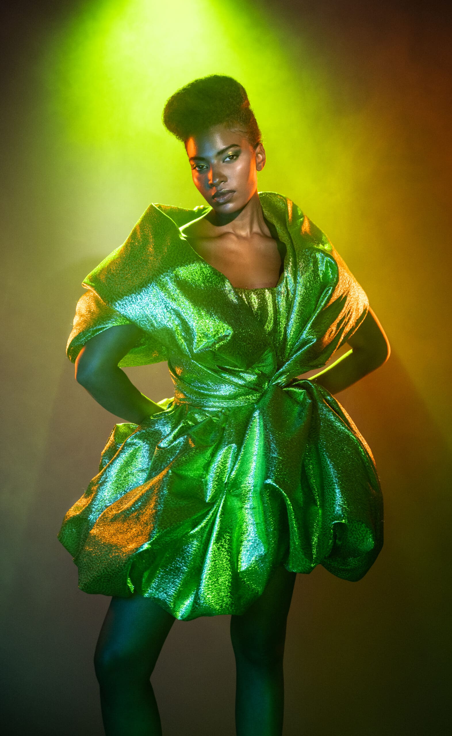 Photoshoot of woman wearing lame green dress.
