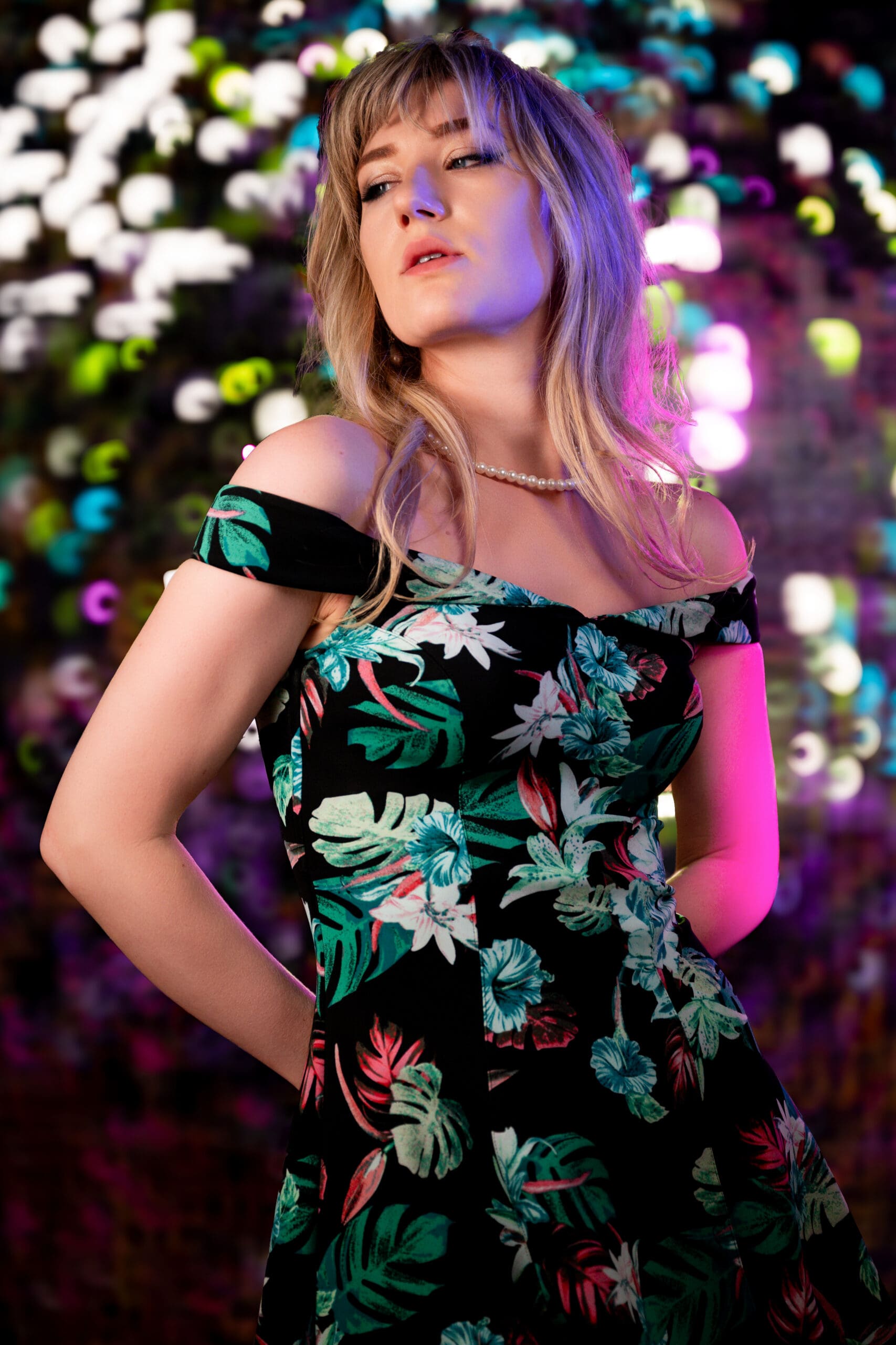 A confident woman standing in golden light, symbolizing transformation and self-expression during Uranus in Gemini
