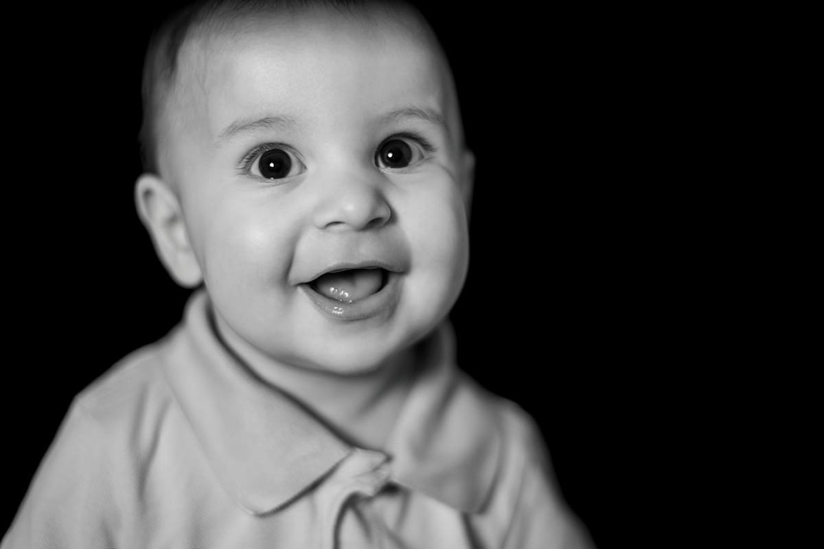 Black and white school portrait of a smiling preschool child photographed by Turron House Studio in Atlanta